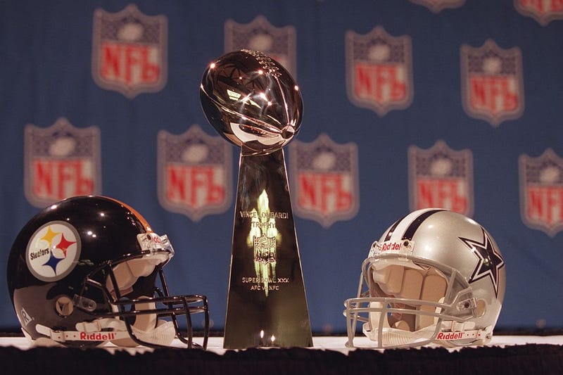 Steelers Cowboys helmets with Lombardi Trophy