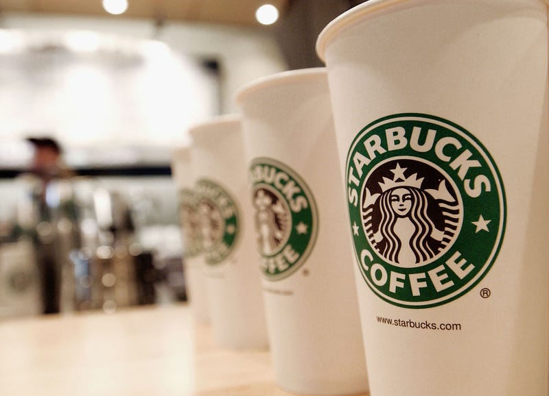 Line of white Starbucks cups