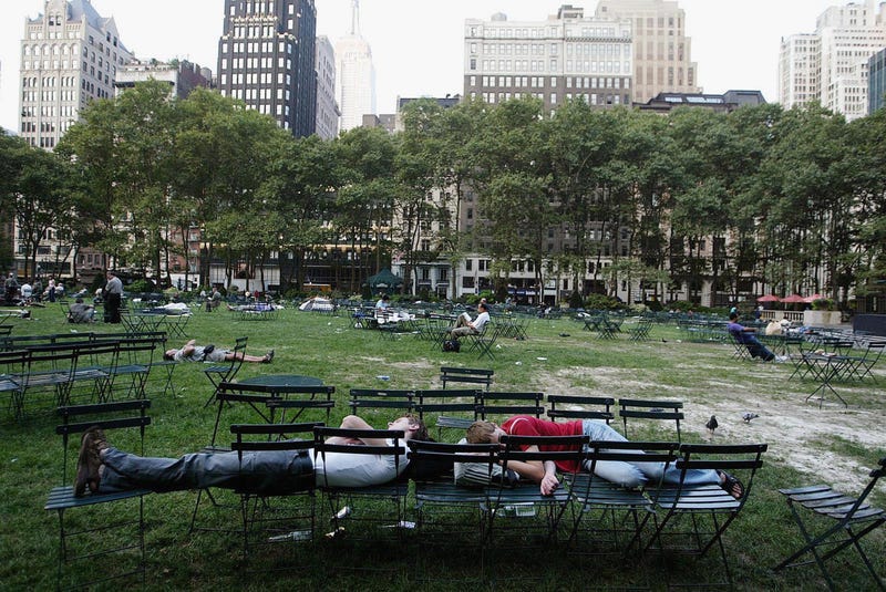Two people sleep in New York's Bryant Park during the blackout.