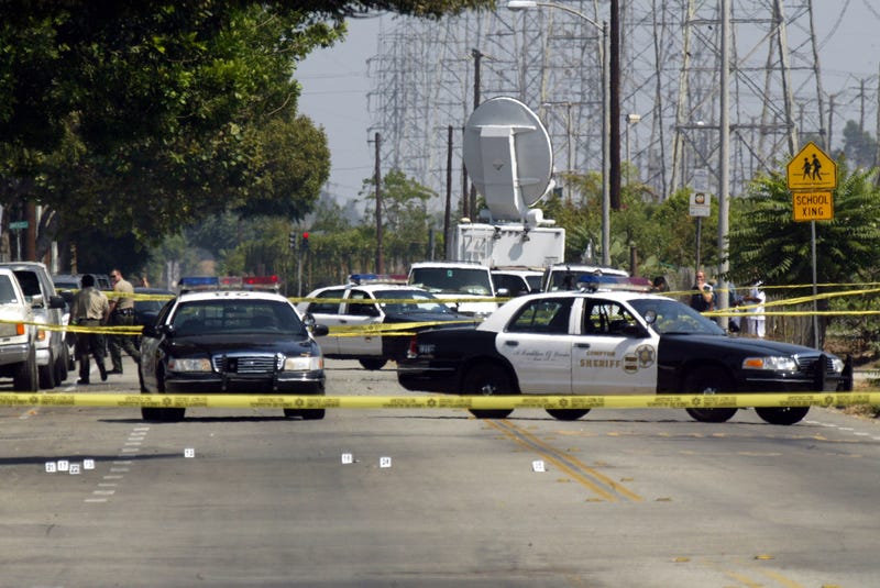 sheriff cars behind police tape