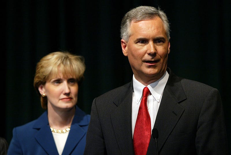 Republican gubernatorial candidate Tom McClintock speaks to reporters with his wife Lori after participating in a denate at California State University, Sacramento September 24, 2003 in Sacramento, California.