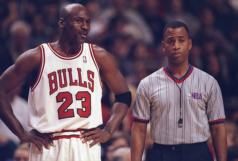 Guard Michael Jordan of the Chicago Bulls confers with an official during a game against the Atlanta Hawks at the United Center in Chicago, Illinois. The Bulls won the game, 97-90. 