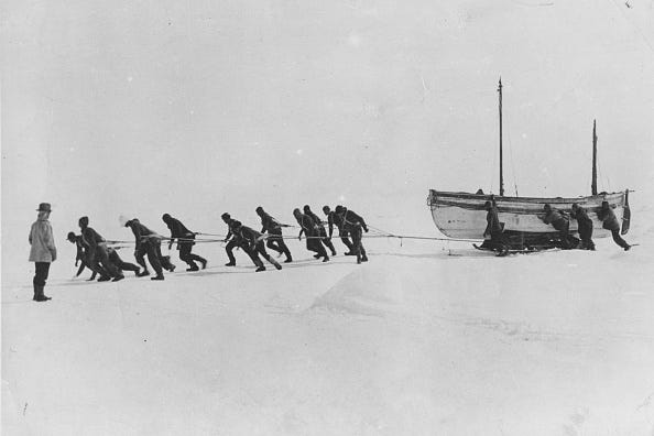 Members of an expedition team led by Irish explorer Sir Ernest Henry Shackleton pull one of their lifeboats across the snow in the Antarctic, following the loss of the 'Endurance'. 