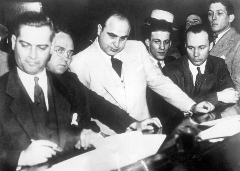 Al Capone (1899 - 1947) signing Uncle Sam's $50,000 bail bond in the Federal Building, Chicago. 