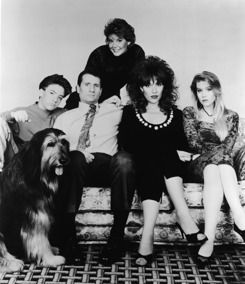 A promotional portrait of the cast of the television series 'Married With Children,' 1990. (L-R) David Faustino, Ed o'Neill, Katey Segal, Christina Applegate, and Amanda Bearse (standing at back).