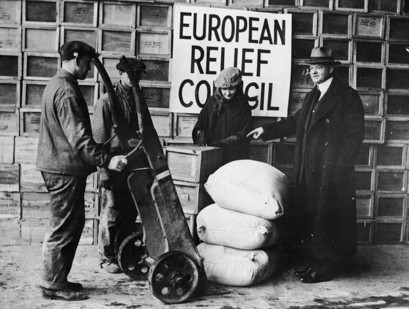 American politician and later the 31st President of the United States, Herbert Hoover, overseeing the shipping of relief supplies to post-war Europe from the Bush Docks in Brooklyn, New York. 