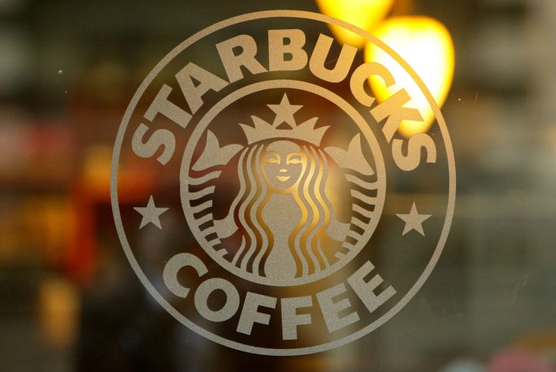 A logo is seen on the glass storefront door of a Starbucks coffee shop on January 22, 2004 in San Francisco, California. (Photo by Justin Sullivan/Getty Images)