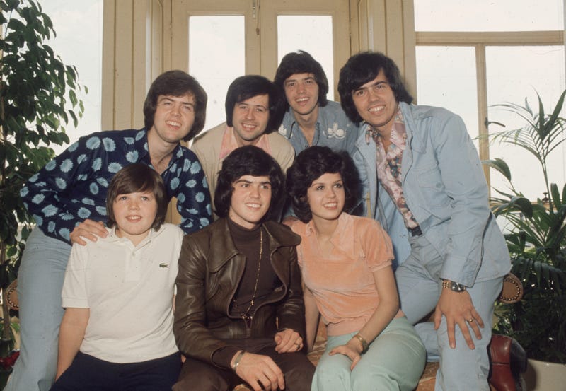 circa 1975: The Osmonds, known as the first family of pop. In the front row are (left to right) Jimmy, Donny and Marie Osmond. Behind them are brothers Alan, Wayne, Merrill and Jay. (Photo by Hulton Archive/Getty Images)