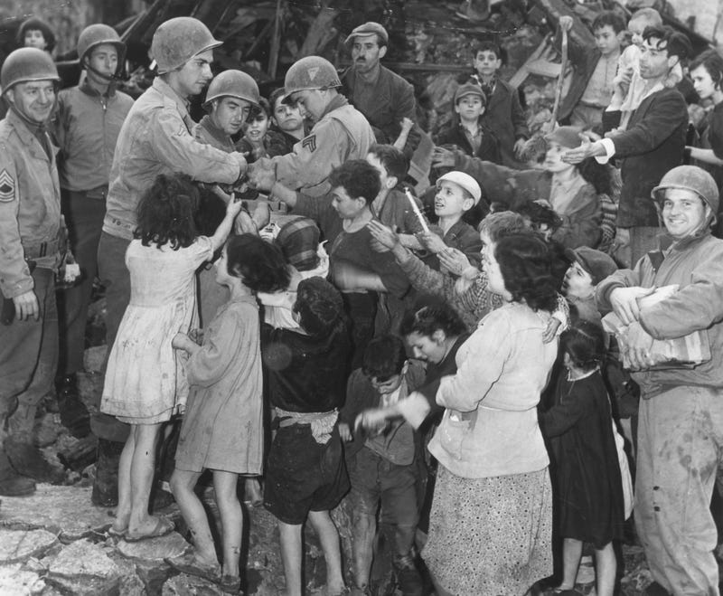 GI's hand out supplies to Italian children on Christmas