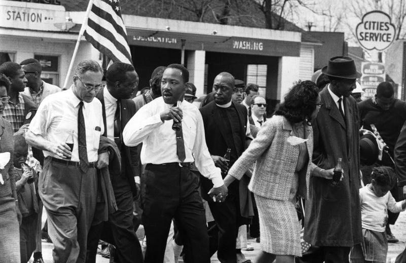 Dr. Martin Luther King, Jr. marching with supporters