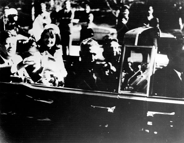 President John F. Kennedy (1917 - 1963) and First Lady Jacqueline Kennedy ride with Texas Governor John Connally and others in an open car motorcade shortly before the president was assassinated in Dallas, Texas, November 22, 1963. (Photo by Keystone/Getty Images)