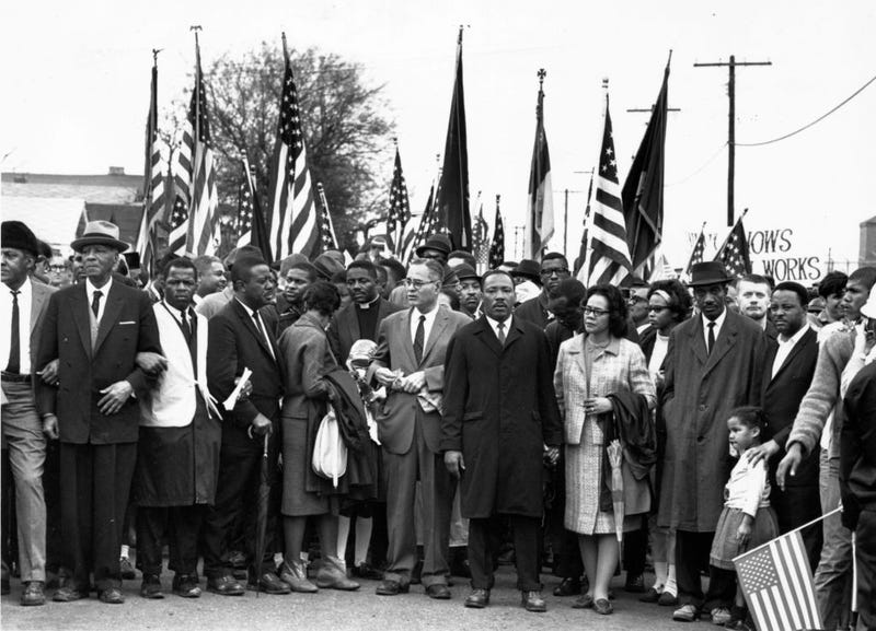 FILE - Civil rights campaigner Dr Martin Luther King (pictured center, right) with his wife Coretta Scott King at a black voting rights march from Selma, Alabama, to the state capital in Montgomery in March 1965. Among the group are civil rights activists Bayard Rustin, John Lewis, Reverend Ralph Abernathy, Ralph Bunche, and Hosea Williams.