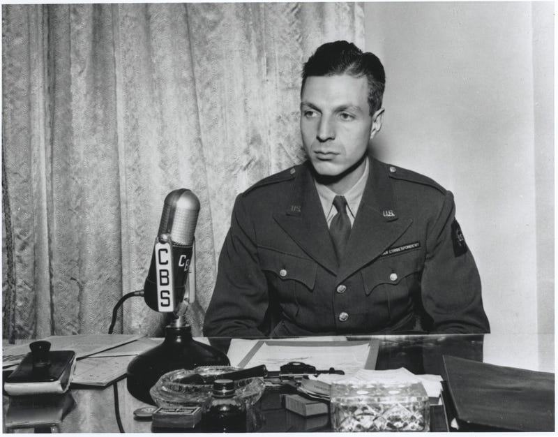 CBS News correspondent Richard C. Hottelet seated at a microphone and dressed in a U.S. war correspondent uniform in 1944