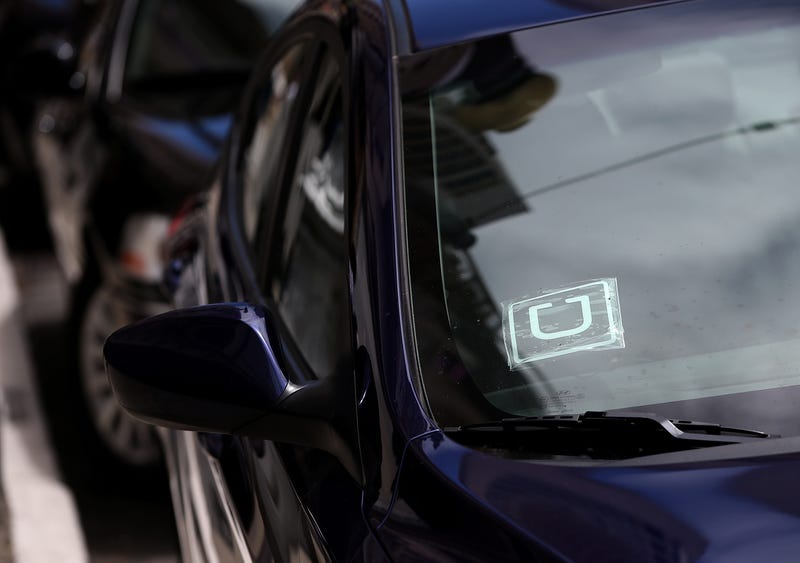 A sticker with the Uber logo is displayed in the window of a car on June 12, 2014 in San Francisco, California. 
