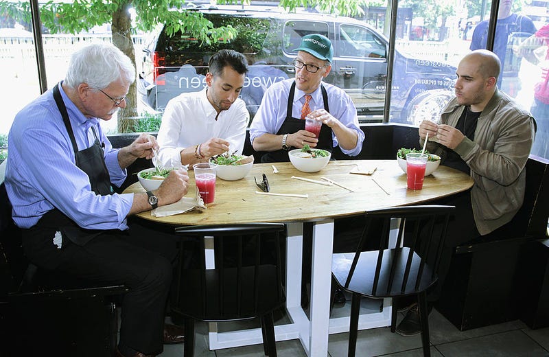U.S. Labor Secretary Thomas Perez (3rd L) and Representative George Miller (D-CA) (L) eat lunch with co-founders of sweetgreen restaurant, Nicolas Jammet (R) and Jonathan Neman (2nd L), at one of sweetgreen's locations June 16, 2014 at Dupont Circle in Washington, DC.