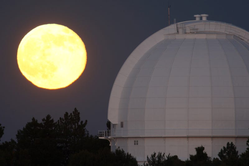 The Moon, rises behind the historic Mount Wilson Observatory on July 12, 2014 at Mount Wilson in the Angeles National Forest northeast of Los Angeles, California.