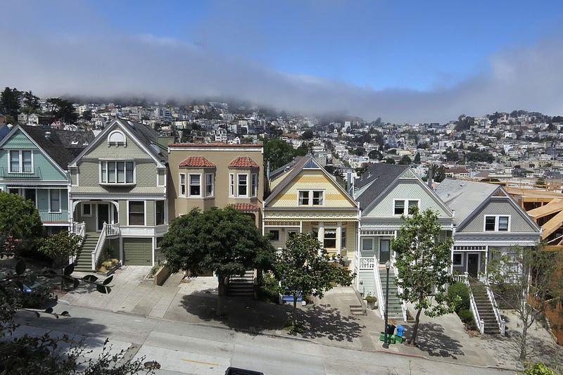 Residential houses line a street in Mission district near Delores Park as typical summer fog rolls in on July 4, 2014 in San Francisco, California. 