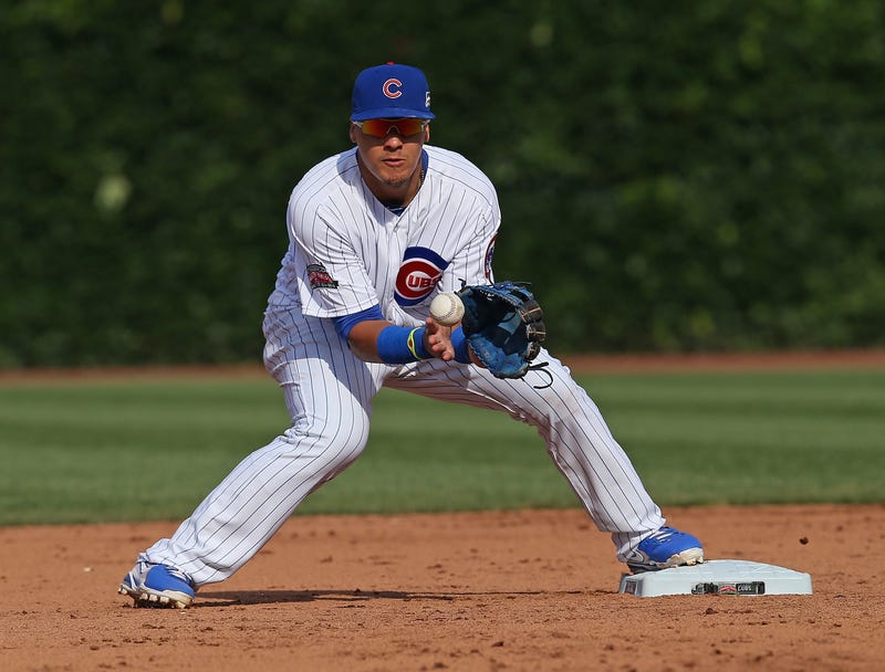 Javy Baez #9 of the Chicago Cubs makes a fielding error against the Tampa Bay Rays at Wrigley Field on August 9, 2014 in Chicago, Illinois.