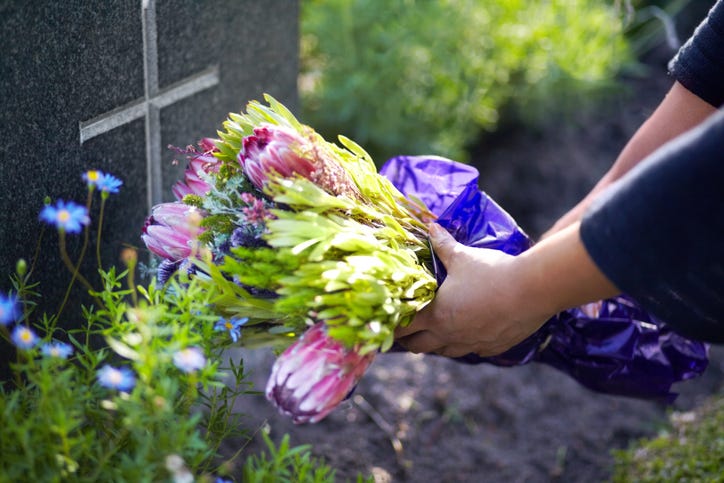 placing flowers on a grave