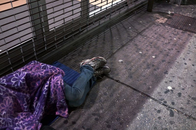 A homeless person sleeps on a Manhattan street on August 22, 2014 in New York City. According to the Department of Homeless Services, the number of homeless people in New York City has risen by more than 20,000 over the past five years. 