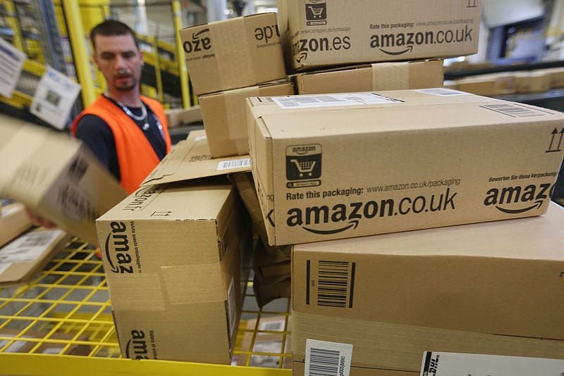 A worker prepares packages for delivery at an Amazon warehouse on September 4, 2014 in Brieselang, Germany.