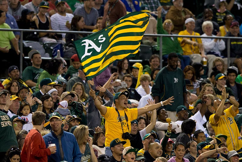 An Oakland Athletics fan waves a flag in the stands during the fifth inning against the Los Angeles Angels of Anaheim at O.co Coliseum on September 23, 2014 in Oakland, California.