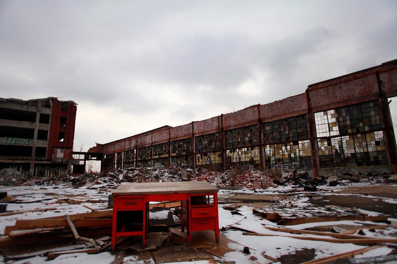 Abandoned scrapyard/building with red desk in foreground