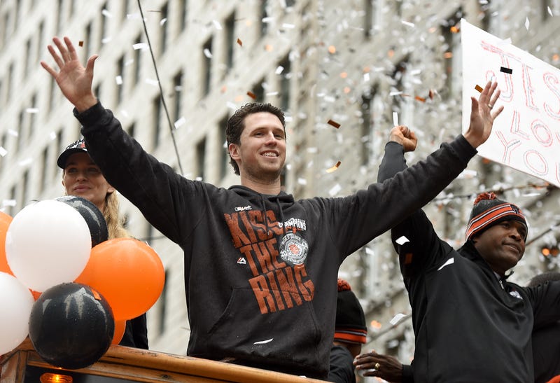 Buster Posey #28 of the San Francisco Giants, waves to the crowd along the parade route during the San Francisco Giants World Series victory parade on October 31, 2014 in San Francisco, California.