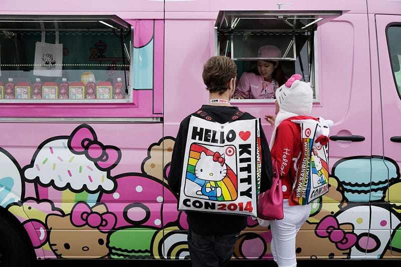 Attendees order food from a food truck outside of Hello Kitty Con