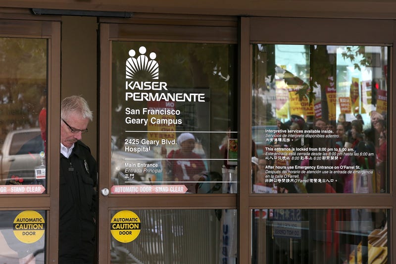 A security guard looks through a window as nurses strike outside of Kaiser Permanente hospital on November 11, 2014 in San Francisco, California.