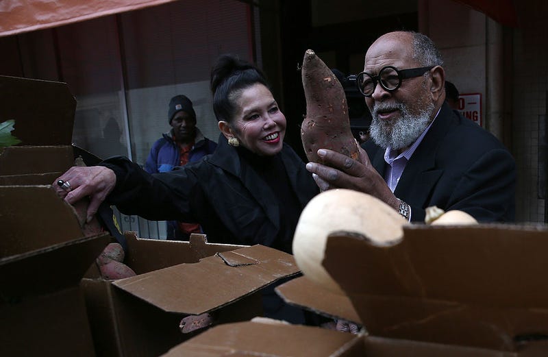 Glide Memorial Church pastor Rev. Cecil Williams (R) and his wife Janice Mirikitani (L) looks at donated produce outside of Glide Memorial Church on November 19, 2014 in San Francisco, California.