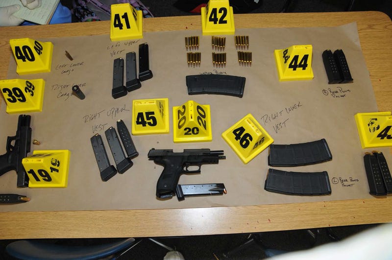 In this handout crime scene evidence photo provided by the Connecticut State Police, shows firearms and ammunition found on or in close proximity to shooters body at Sandy Hook Elementary School following the December 14, 2012 shooting rampage, taken on an unspecified date in Newtown, Connecticut. A second report was released December 27, 2013 by Connecticut State Attorney Stephen Sedensky III gave more details of the the Newtown school shooting by Adam Lanza that left 20 children and six women educators dead inside Sandy Hook Elementary School after killing his mother at their home.