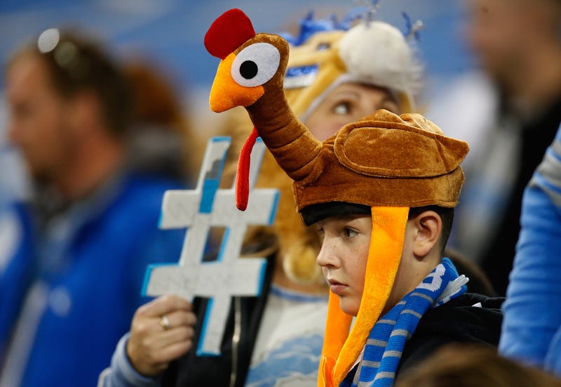 A young fan with a turkey hat looks on during the traditional Thanksgiving day game in Detroit, Michigan. 