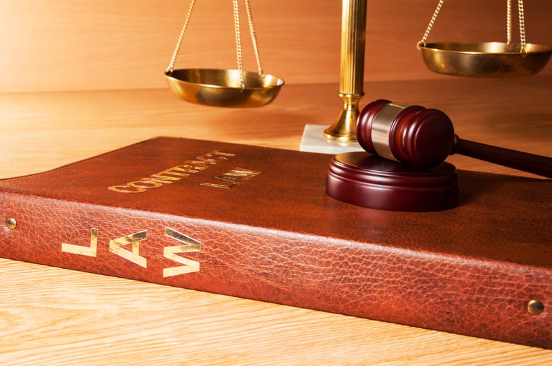 Justice gavel with scales in the background