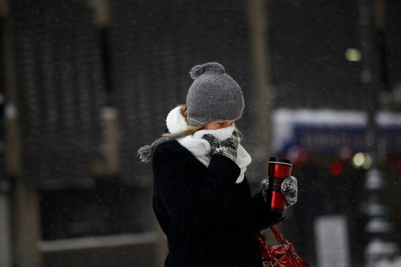 DETROIT, MI - JANUARY 6: A woman covers her face from the cold as the area deals with freezing weather in Detroit, Michigan