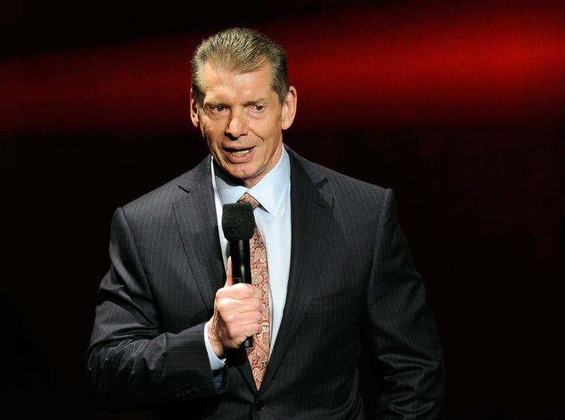Vince McMahon speaking with microphone