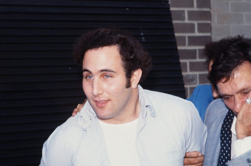 Police officers escort David Berkowitz into the 84th precinct station on Aug. 10, 1977
