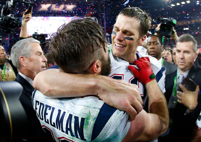Tom Brady #12 and Julian Edelman #11 of the New England Patriots celebrate after defeating the Seattle Seahawks 28-24 to win Super Bowl XLIX at University of Phoenix Stadium on February 1, 2015 in Glendale, Arizona.