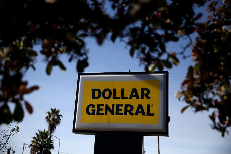 A sign is posted in front of a Dollar General store