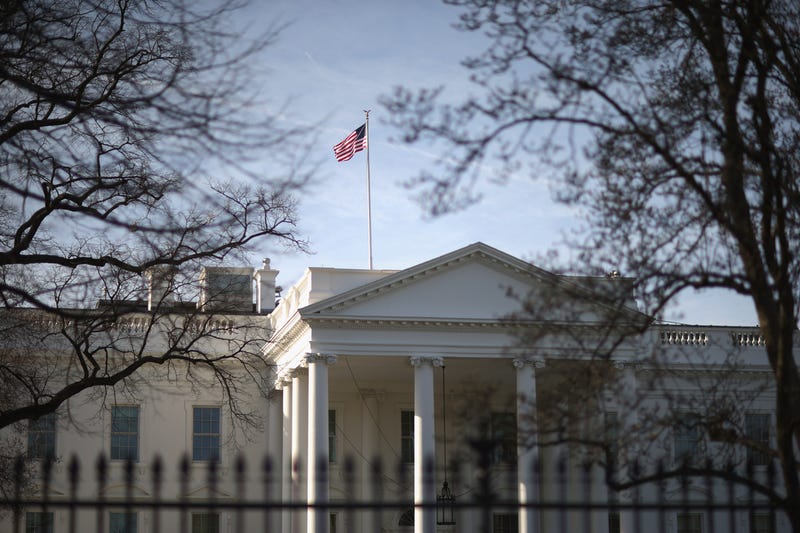 Morning sunlight strikes the flag flying above the White House March 18, 2015 in Washington, DC.