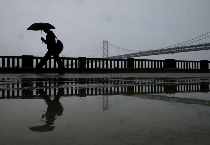 A pedestrian carries an umbrella while walking near the Bay Bridge on February 6, 2014 in San Francisco, California.