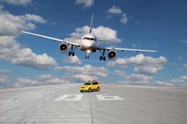 Car blocking a plane from landing on a runway