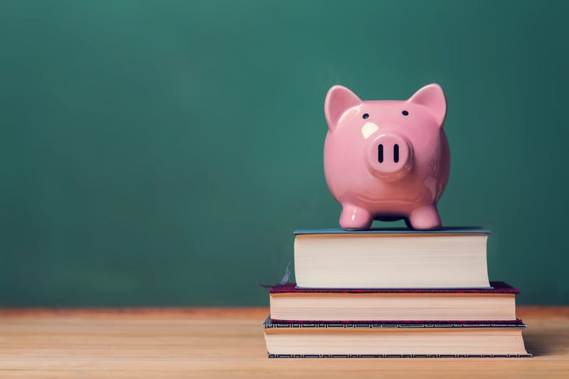 Piggy bank on top of books