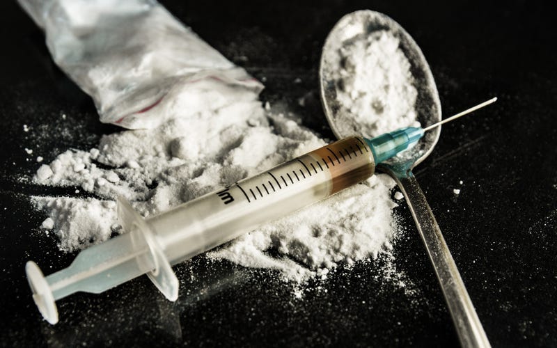 syringe and spoon with heroin