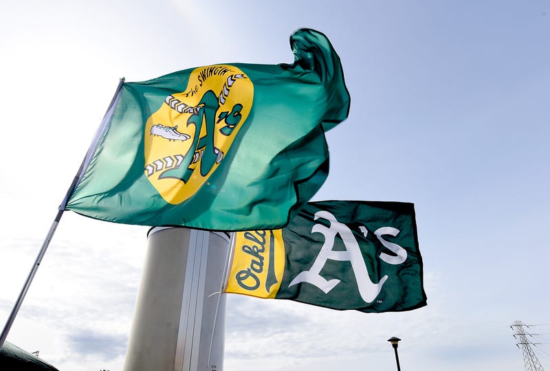 Oakland Athletics flags fly in Oakland Coliseum parking lot. 