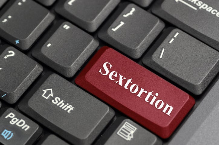 Red sextortion key on keyboard