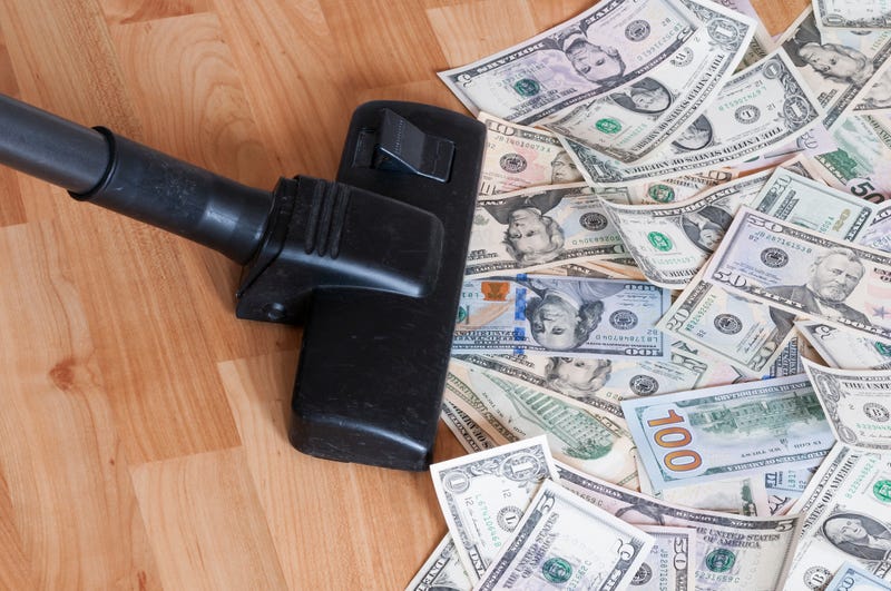 Vacuum cleaner sucks on U.S. dollars.