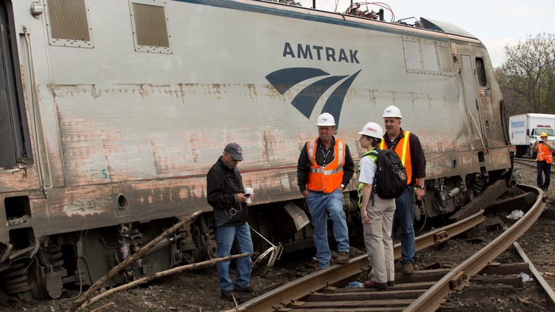 NTSB Recorder Specialist Cassandra Johnson (second from right) works with officials on the scene of the Amtrak Train 188 derailment on May 13, 2015 in Philadelphia, Pennsylvania. 