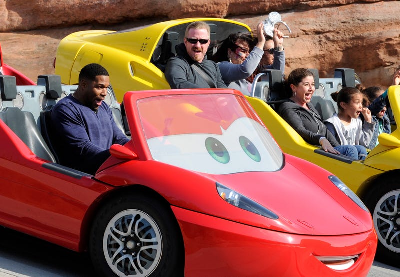 In this handout photo provided by Disney Parks, host Michael Strahan gears up for "LIVE's" five shows from Disneyland Resort with a ride on the Cars Land Radiator Springs Racers at Disney California Adventure on May 16, 2015 in Anaheim, California.