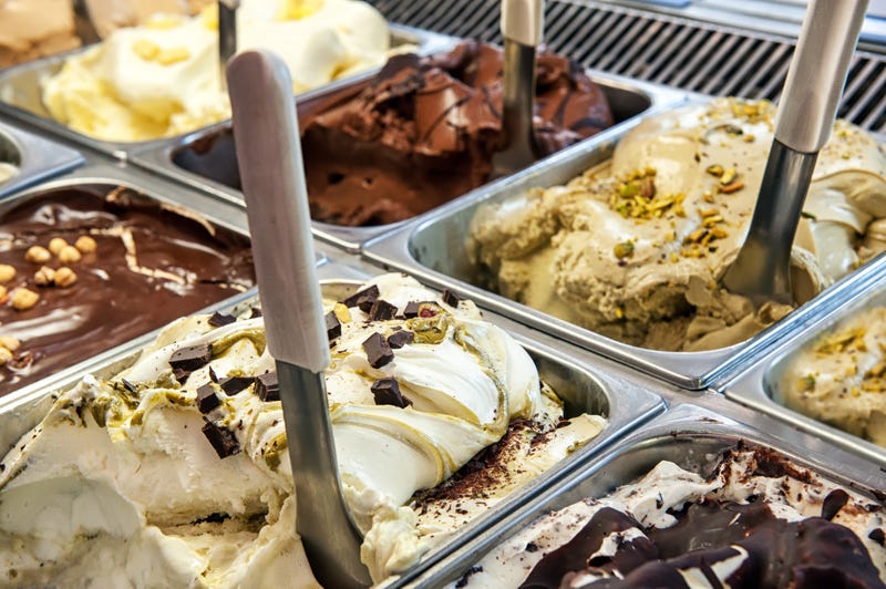 Close up of trays of different ice cream in assorted flavors.